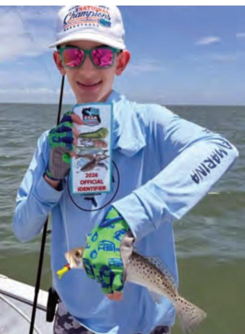 Youth angler with a speckled trout and a CCA Florida STAR identifier