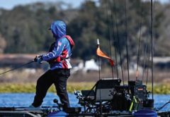 Angler casting from a fishing kayak on a Florida lake