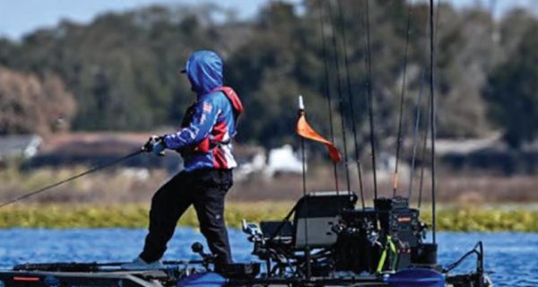Angler casting from a fishing kayak on a Florida lake