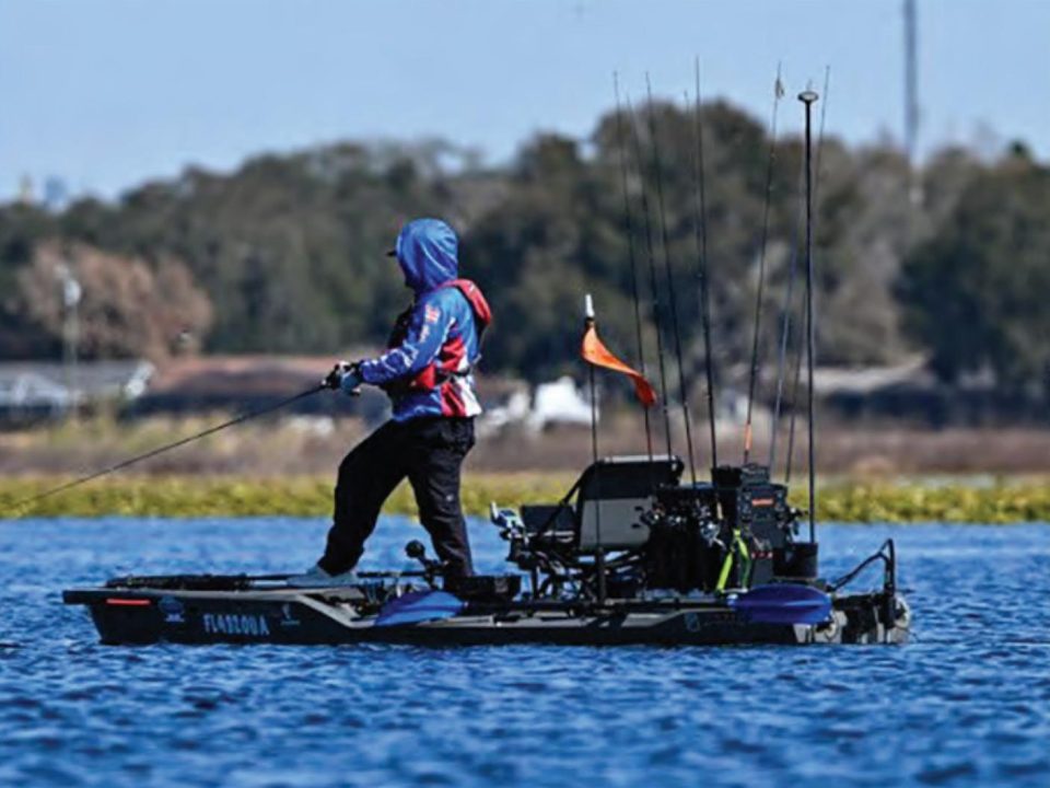 Angler casting from a fishing kayak on a Florida lake