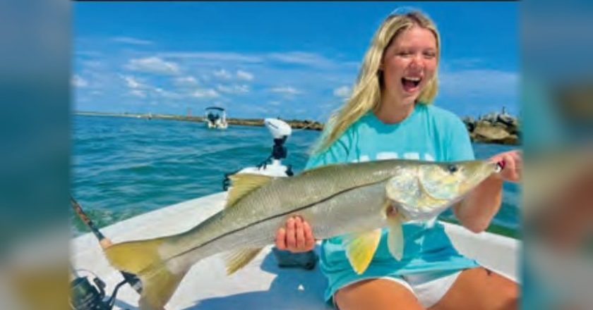 Young angler holding a big snook