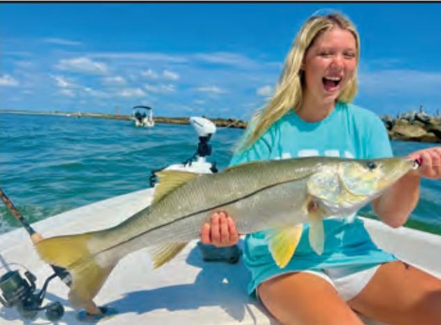Young angler holding a big snook