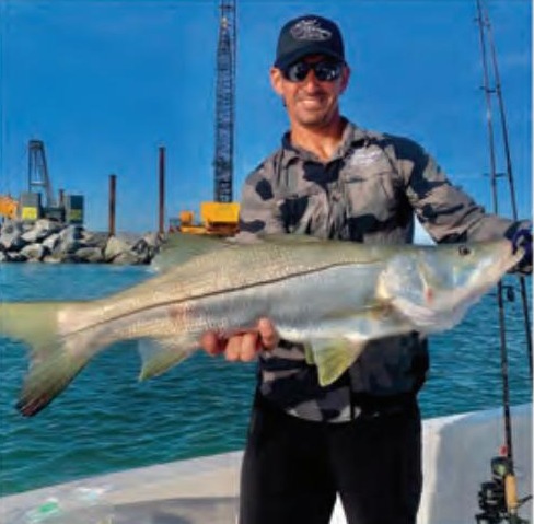 Captain Marty Goldys of Reel Harmony Fishing Charters holding a snook