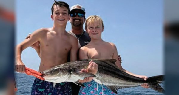 Youth anglers Mikey Stamps and Quintin Ray with Capt. Evan Sanders and their cobia