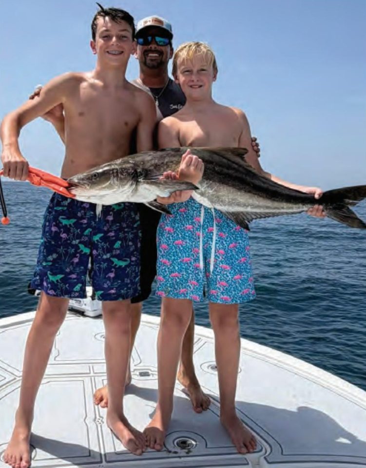 Youth anglers Mikey Stamps and Quintin Ray with Capt. Evan Sanders and their cobia