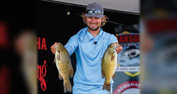 Pro bass angler Joey Bloom holding two smallmouth bass