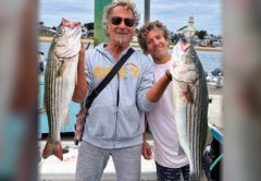 Marco Pompano and a friend holding striped bass