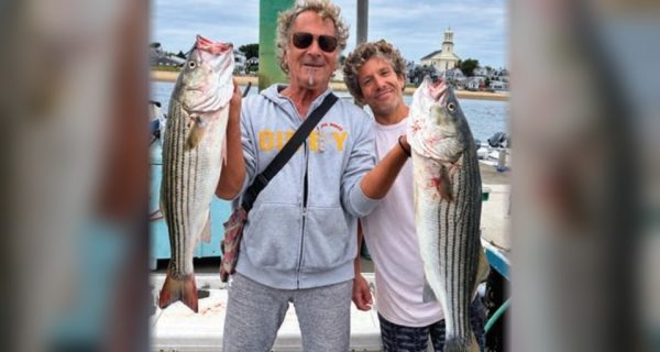 Marco Pompano and a friend holding striped bass