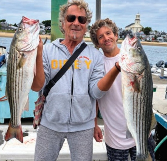 Marco Pompano and a friend holding striped bass
