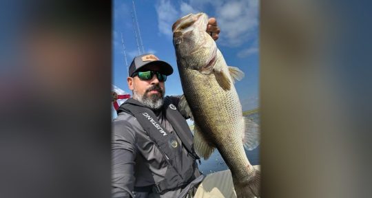 Jessie Diaz holding a big largemouth bass