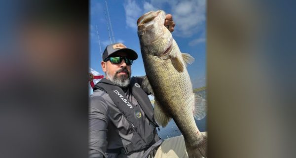 Jessie Diaz holding a big largemouth bass