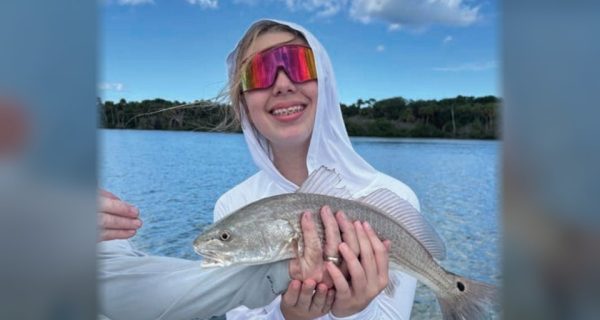 Youth angler of the month Mya LeMand holding a redfish