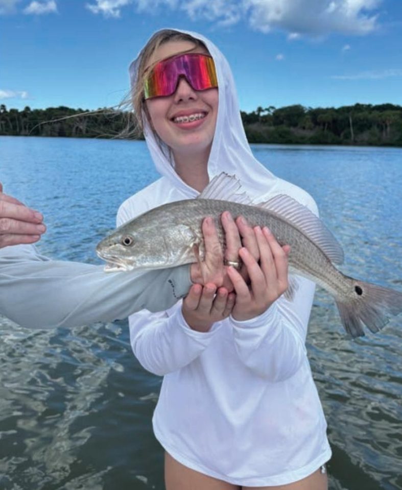 Youth angler of the month Mya LeMand holding a redfish
