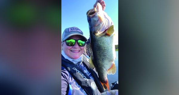 Angler holding a largemouth bass