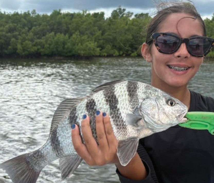 Young angler holding a sheepshead in the Edgewater backcountry